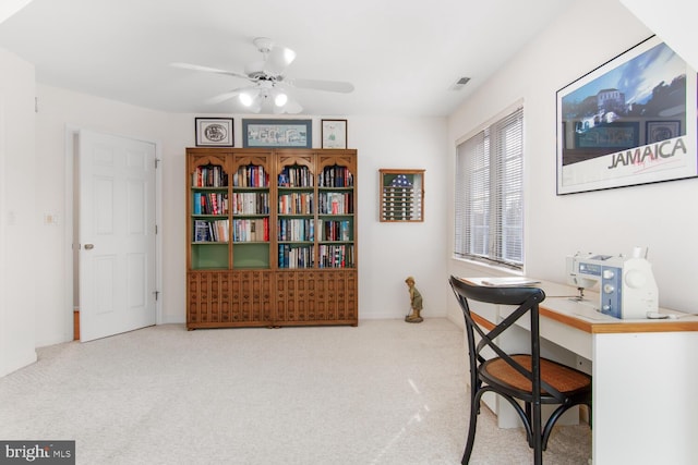 office area with ceiling fan and carpet