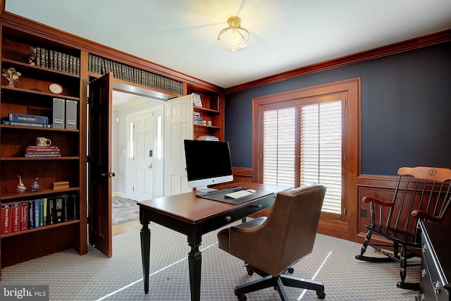 carpeted office featuring built in shelves and ornamental molding