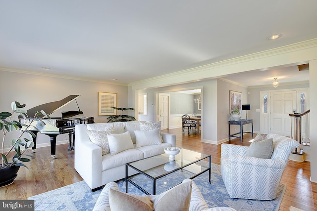 living room featuring ornamental molding and light hardwood / wood-style floors