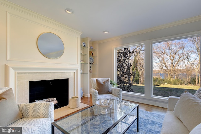 living room featuring hardwood / wood-style flooring and ornamental molding