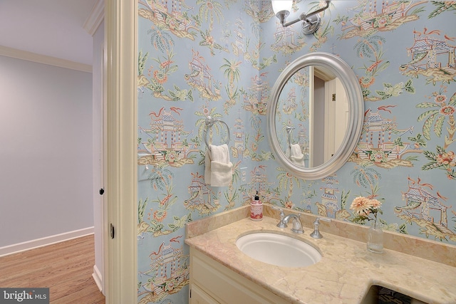 bathroom with vanity, hardwood / wood-style floors, and crown molding