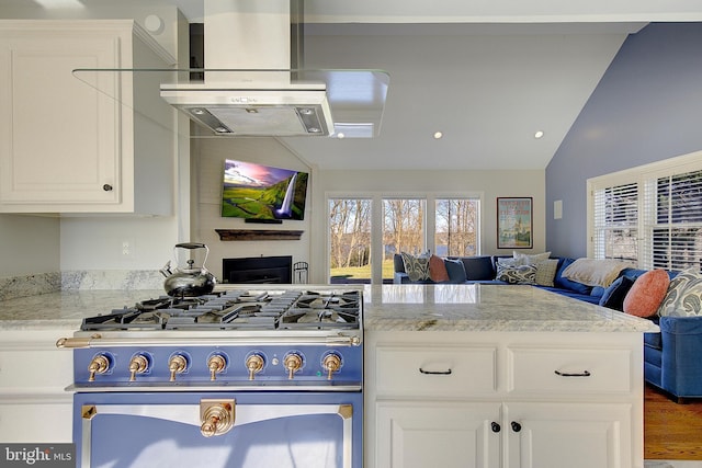 kitchen featuring stove, light stone countertops, vaulted ceiling, and range hood