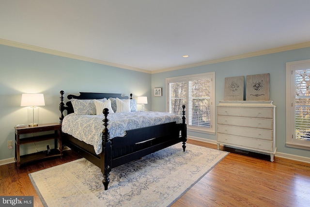 bedroom with hardwood / wood-style floors and ornamental molding