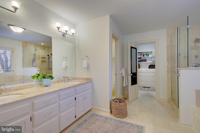 bathroom with vanity and a shower with shower door