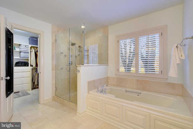 bathroom featuring tile patterned flooring and shower with separate bathtub