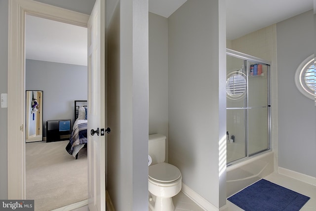 bathroom with bath / shower combo with glass door and toilet