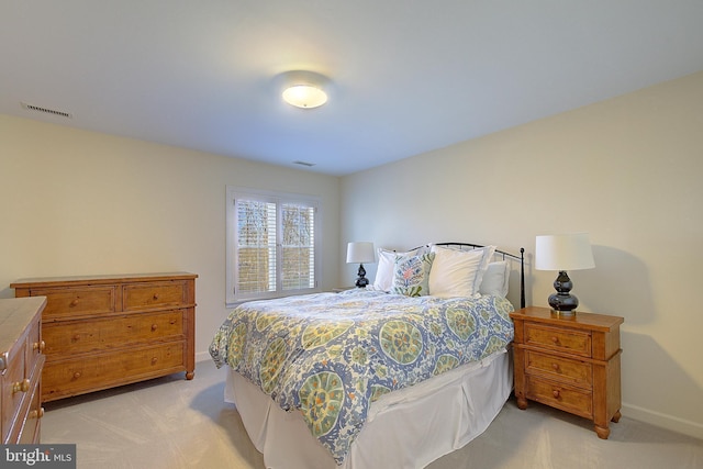 bedroom featuring light colored carpet