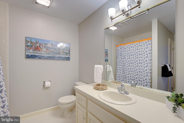 bathroom with vanity, tile patterned floors, and toilet