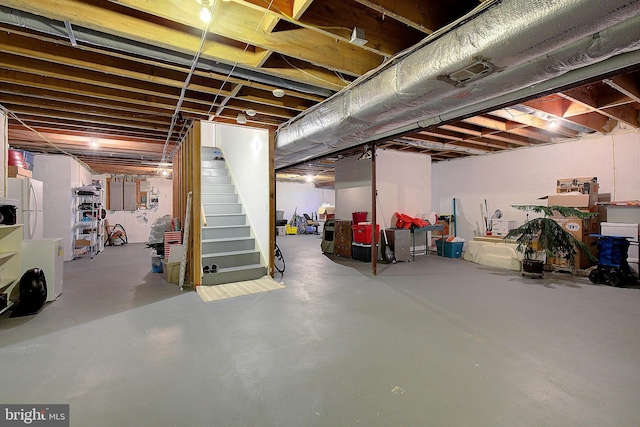 basement featuring white refrigerator and electric panel