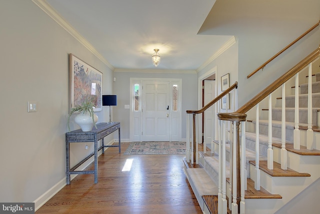 entryway featuring crown molding and hardwood / wood-style floors