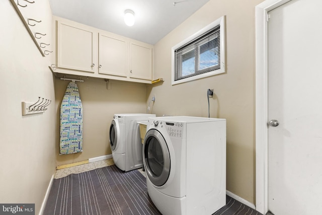 laundry room with cabinets, dark hardwood / wood-style floors, and washer and clothes dryer