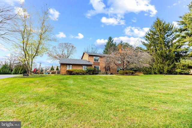 split level home featuring a front lawn