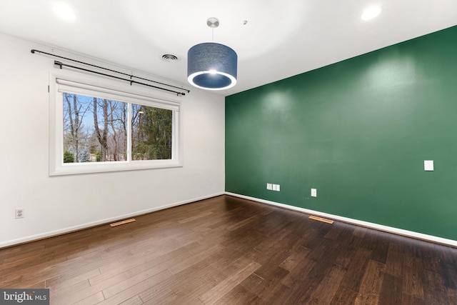 empty room featuring hardwood / wood-style flooring