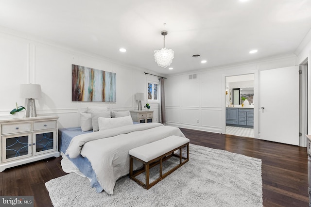 bedroom featuring connected bathroom, dark wood-type flooring, and ornamental molding