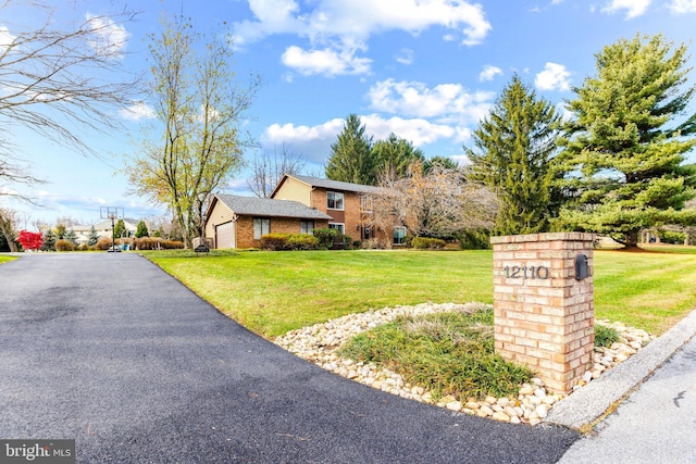 view of front of property featuring a garage and a front yard