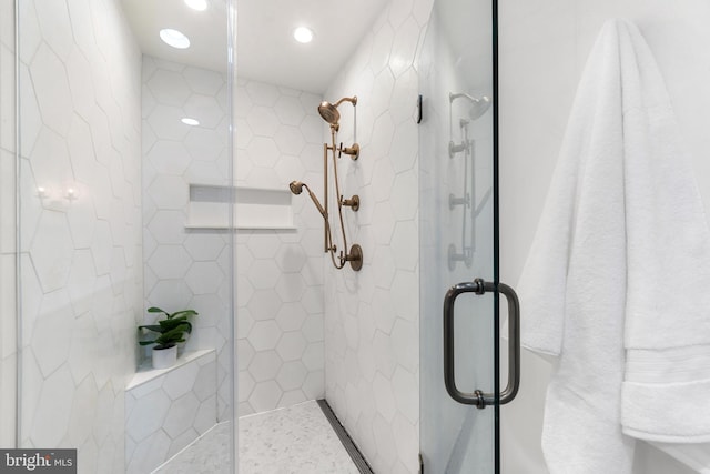 bathroom featuring a shower with door