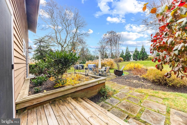 wooden terrace featuring a patio area