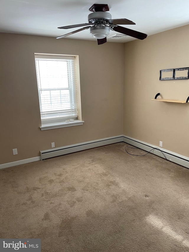 carpeted empty room with baseboard heating and ceiling fan