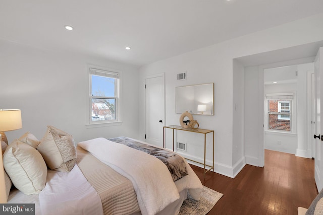 bedroom with dark hardwood / wood-style floors