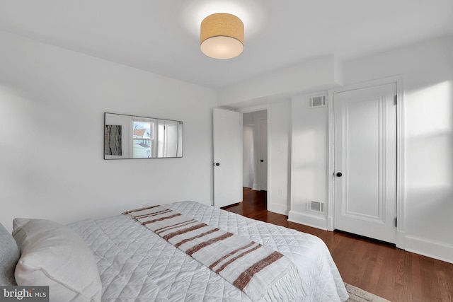 bedroom featuring dark hardwood / wood-style flooring