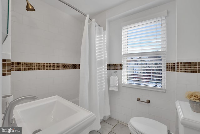 bathroom with sink, tile walls, tile patterned flooring, toilet, and walk in shower