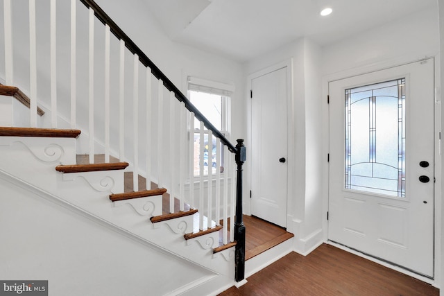 entrance foyer featuring dark wood-type flooring and a healthy amount of sunlight