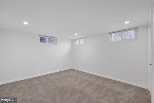 basement featuring light colored carpet