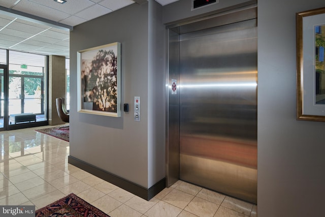 425 Windmere Dr Unit 2B, State College, PA 16801 - interior space with elevator, light tile patterned floors, a paneled ceiling, and a wall of windows