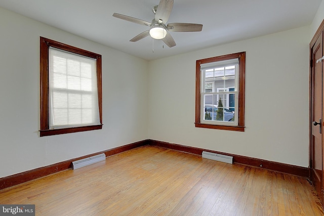 empty room featuring ceiling fan and light hardwood / wood-style floors