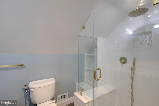 bathroom with vaulted ceiling, toilet, and walk in shower