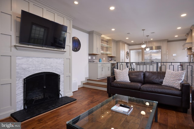 living room with crown molding and dark hardwood / wood-style floors