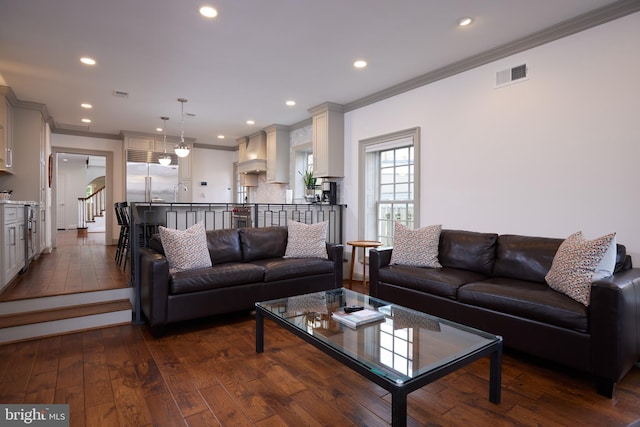 living room with sink, dark wood-type flooring, and ornamental molding