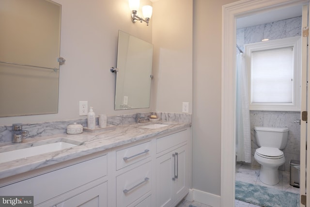 bathroom featuring toilet and vanity