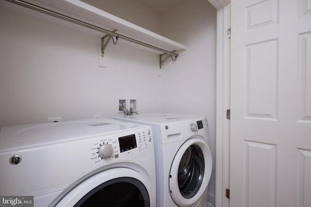 washroom featuring washer and clothes dryer