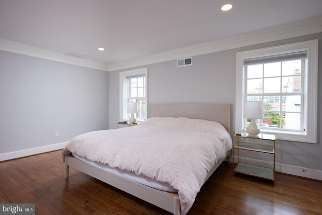 bedroom featuring crown molding and dark hardwood / wood-style flooring