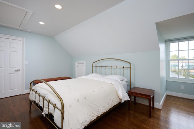 bedroom with dark hardwood / wood-style flooring and lofted ceiling