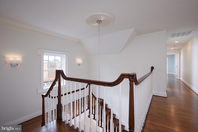 stairway featuring hardwood / wood-style flooring and vaulted ceiling