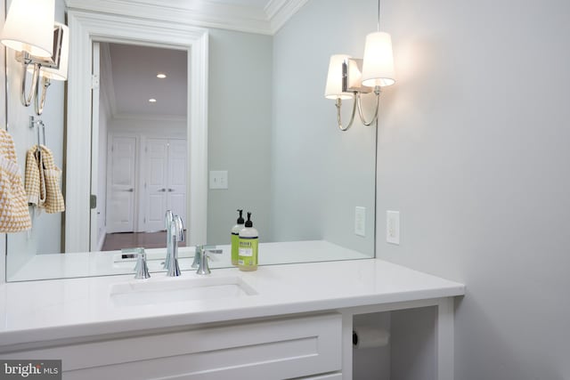 bathroom with vanity and ornamental molding