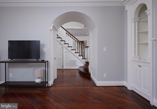 entrance foyer with crown molding and dark wood-type flooring