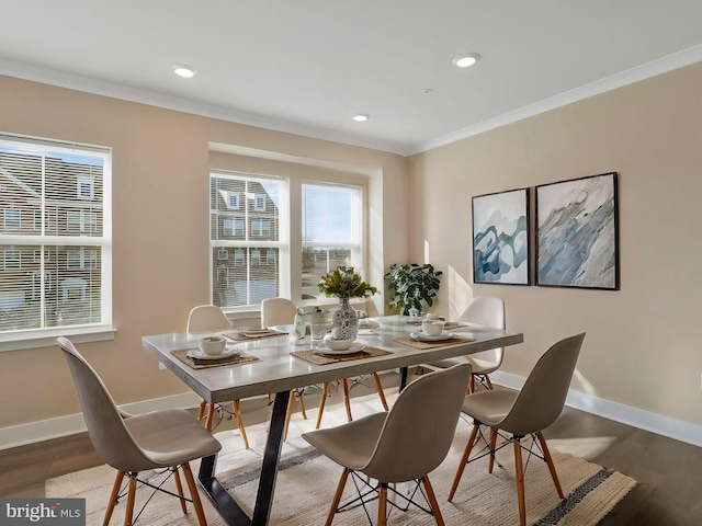 dining room featuring hardwood / wood-style floors, crown molding, and a healthy amount of sunlight