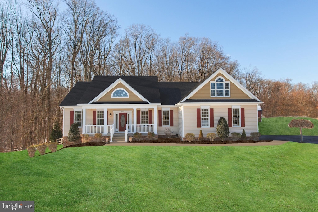 view of front of property with covered porch and a front yard