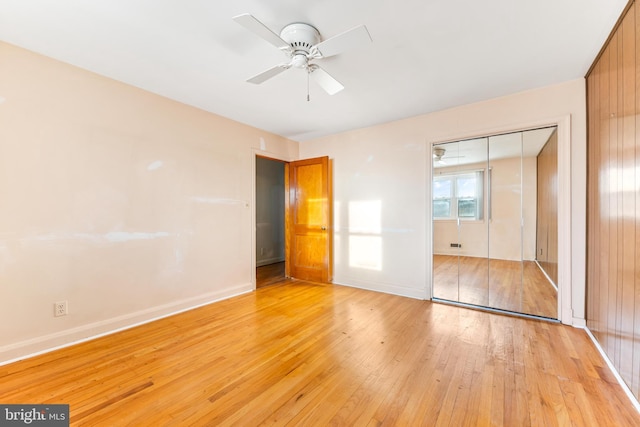 unfurnished bedroom with ceiling fan, light hardwood / wood-style floors, and a closet