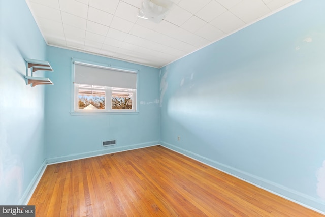 spare room with hardwood / wood-style flooring