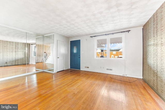 empty room with hardwood / wood-style floors