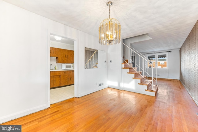 interior space featuring sink, hardwood / wood-style floors, and a chandelier