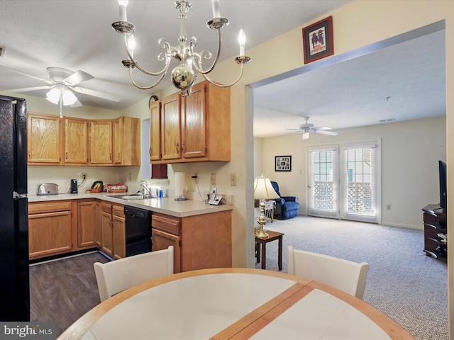 kitchen with sink, dark colored carpet, hanging light fixtures, black dishwasher, and ceiling fan