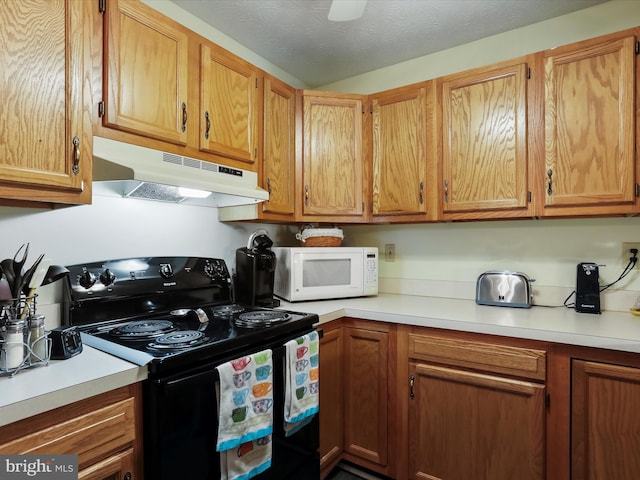 kitchen featuring black electric range and a textured ceiling