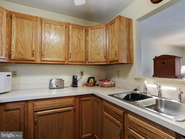 kitchen with sink and a textured ceiling