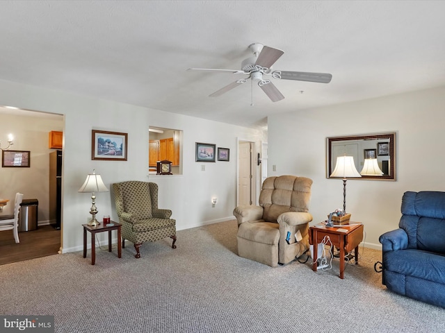 living room featuring carpet and ceiling fan