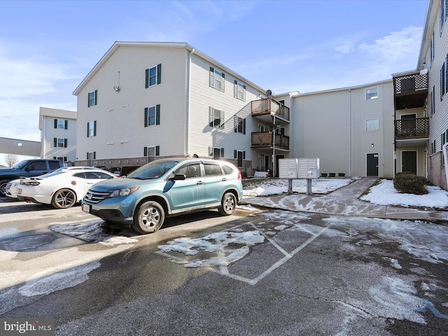 view of car parking with a mail area